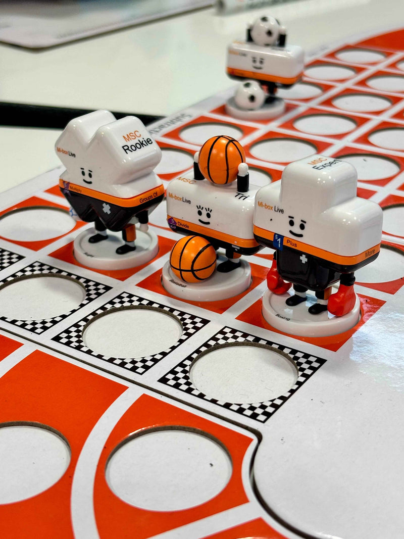 Toy figures on a board game with basketball theme
